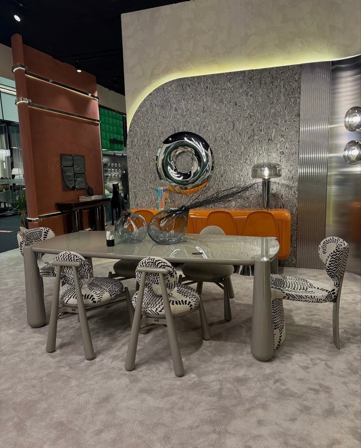 Lowlight modern lacquer furniture collection with sculptural orange sideboard, statement coffee tables, and contemporary dining design.